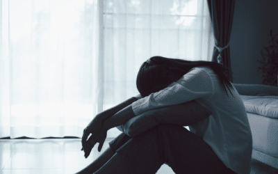 Mujer abrazándose a sí misma: la desconexión emocional como mecanismo de protección